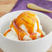 A bowl of ice cream with Oringer Caramel Dessert topping.