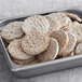 A white tray of Impossible Foods plant-based sausage patties.