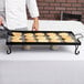 A chef cooking pancakes on an American Metalcraft wrought iron griddle.