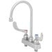 A silver stainless steel Eversteel deck-mount kitchen faucet with two wrist action handles.