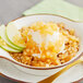 A bowl of oatmeal with a scoop of ice cream and Oringer apple topping.