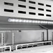 An Avantco 48" VersaHub refrigerated sandwich prep table with white doors.