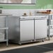 A stainless steel 48-inch front-breathing undercounter refrigerator with two doors, designed for commercial kitchen use.