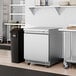 An Avantco stainless steel undercounter freezer with a black handle.
