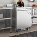 An Avantco VersaHub worktop freezer in a stainless steel commercial kitchen.