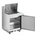 An Avantco stainless steel refrigerator with a door open.