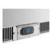 The side of a white Avantco VersaHub refrigerator with a digital clock.