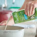 A carton of Pacific Foods Unsweetened Vanilla Hemp Milk being poured into a white pot.