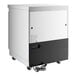 An Avantco white and black undercounter refrigerator with wheels.