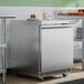 A stainless steel 27-inch front breathing undercounter refrigerator.