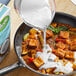 A pan filled with tofu and Pacific Foods Organic Coconut Milk