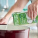 A carton of Pacific Foods Organic Coconut Milk being poured into a pot.