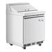 A white Avantco refrigerator with a stainless steel top and an open door.