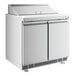 An Avantco white refrigerated sandwich prep table with two doors open.