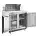 An Avantco stainless steel refrigerator with two open doors.