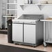 An Avantco 36" 2 door front breathing cutting top refrigerator on a counter in a commercial kitchen.