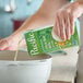 A carton of Pacific Foods Ultra Soy Milk being poured into a pot.