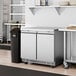 An Avantco stainless steel undercounter refrigerator in a kitchen.