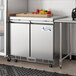 An Avantco stainless steel undercounter freezer with a white rectangular cutting board on top.