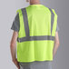 A man wearing a Cordova lime high visibility safety vest.