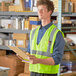 A man wearing a Cordova lime high visibility safety vest holding a clipboard.