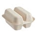 A white World Centric compostable fiber taco clamshell with two compartments containing food.