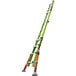 A green Little Giant Conquest 2.0 ladder with black wheels.
