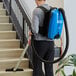 A man vacuuming stairs with a Lavex backpack vacuum.