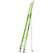 A green Little Giant extension ladder with a black strap.