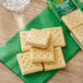 A close up of a box of Keebler Club and Cheddar Sandwich Crackers on a green napkin.