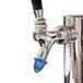 A San Jamar beer tap plug with a blue plastic cap.