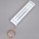 A Taylor 5327 indoor / outdoor thermometer with a wire attached.