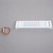A white Taylor indoor/outdoor thermometer with a wire.