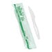 A Stalk Market wrapped white CPLA knife next to a plastic wrapper.