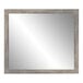 A BrandtWorks mirror with a barnwood gray finish wooden frame.