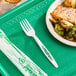 A plate of food on a tray with a Stalk Market white heavy weight CPLA fork.