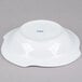 A bright white porcelain pasta serving bowl with a blue rim.