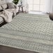 A cream and gray Abani Cabo Collection geometric lined area rug on the floor in a room.