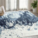 A blue and white Abani Arto Collection area rug with abstract designs on the floor in a room.