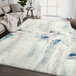 An Abani Arto Collection gray area rug with abstract paint strokes in blue, pink, and white.