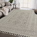 An Abani Layla Collection beige and brown area rug with fringes and tassels.