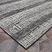 A close up of a Couristan Tangent area rug with a black and white pattern.