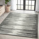 An Abani Casa Collection cream and gray area rug with a modern abstract geometric design in a room.