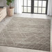 An Abani Casa Collection beige distressed area rug with a Southwestern tribal pattern in a room.