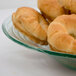 An American Metalcraft green glass bowl filled with bagels.