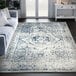 An Abani Casa Collection blue and gray vintage area rug with a blue and white design in a room.