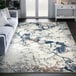 An Abani Casa Collection gray area rug with blue and white abstract designs in a room.