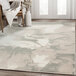 An Abani Arto Collection cream and gray area rug with a liquid marble design on the floor.