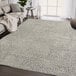 An Abani Layla Collection beige and brown distressed animal print area rug in a room with a couch and blanket.