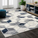 An Abani Arto Collection neutral gray area rug with contemporary geometric cubes in a room.